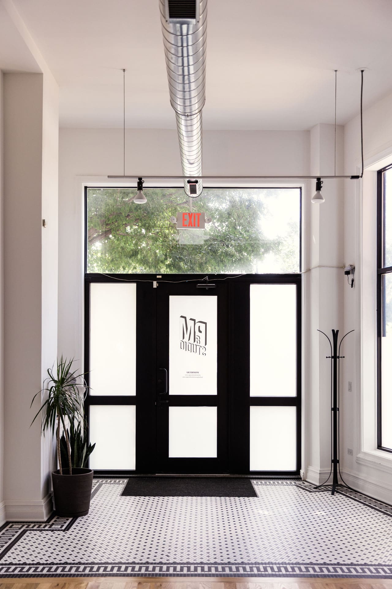 Entryway to Chicago photography studio P&M Studio featuring natural light and black and white tile floor