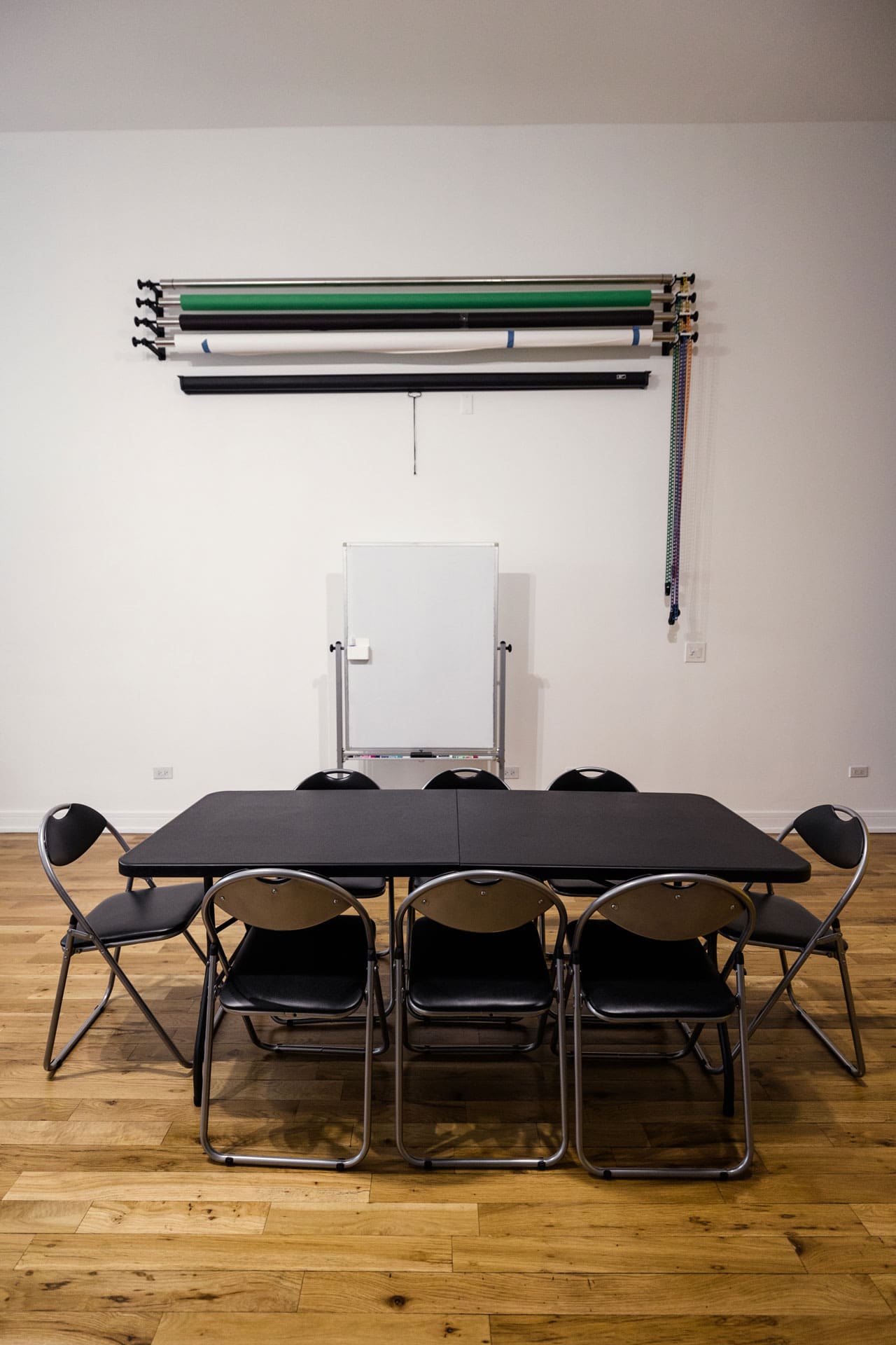 Meeting space with table, chairs and whiteboard at P&M Studio in Chicago's West Town neighborhood