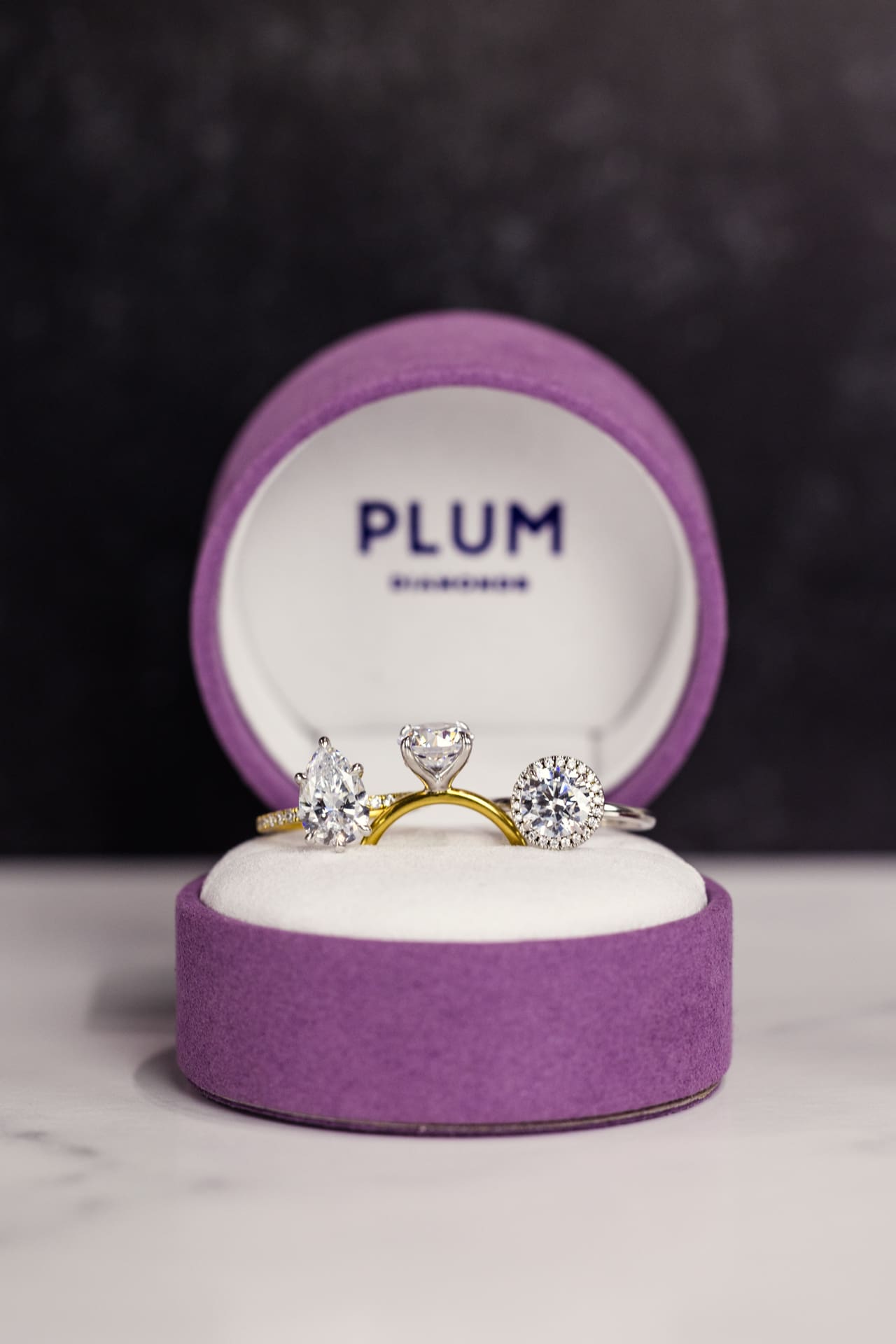 Jewelry product photography for Plum Diamonds with three diamond rings in purple velvet box at Chicago photography studio P&M Studio