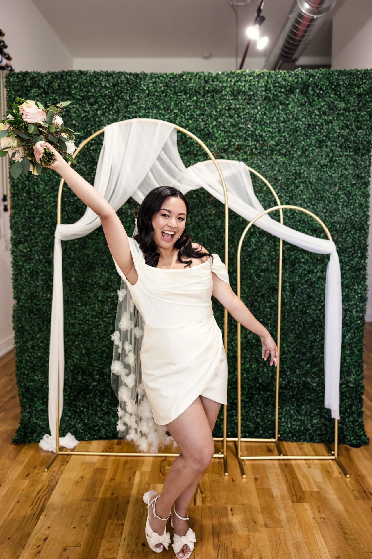 Fun photo of just married bride in floral veil after intimate wedding ceremony at P&M Studio Chicago event space in West Town