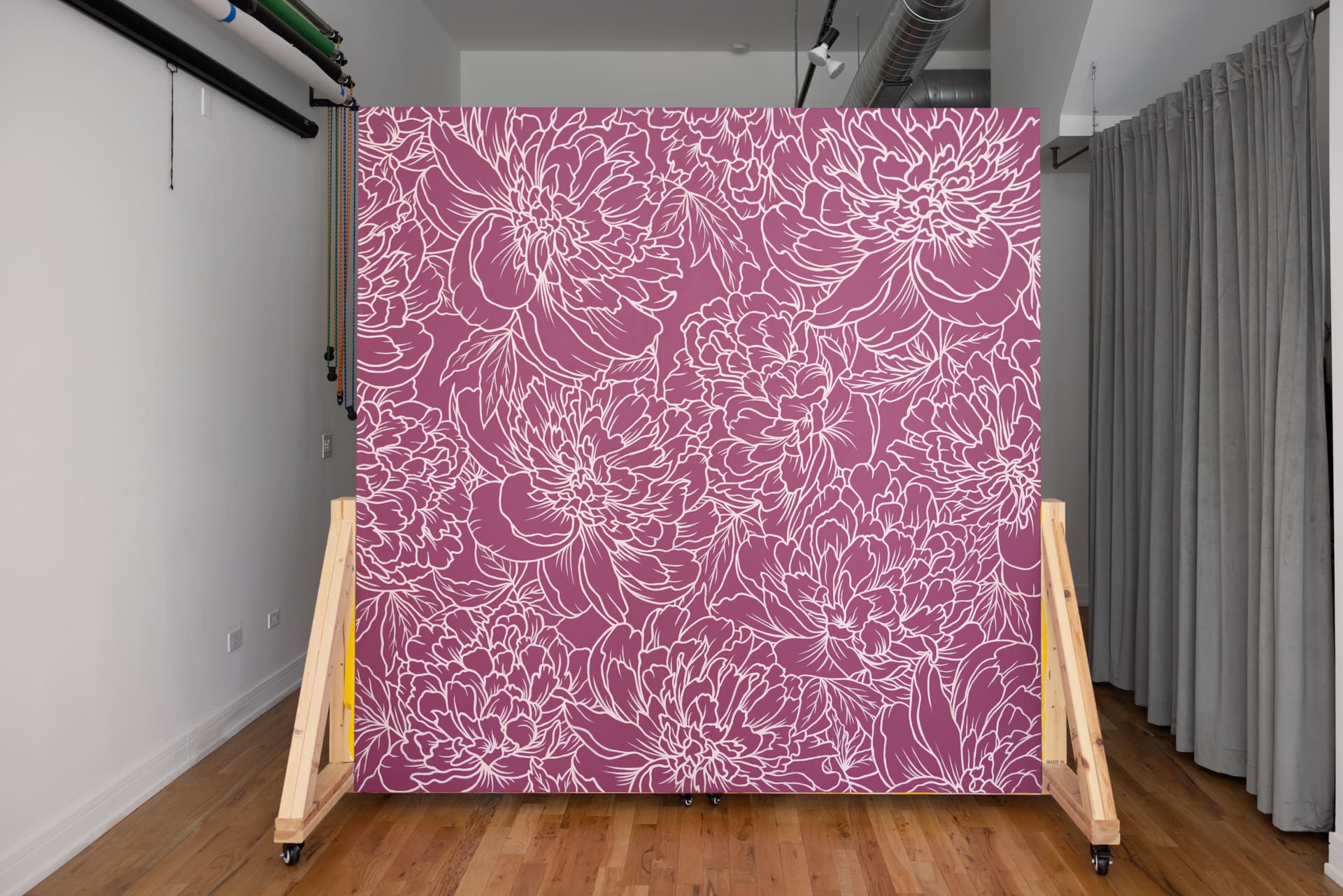 Mobile wall with custom floral mural in Raspberry Crush inside natural light photography studio P&M Studio Chicago